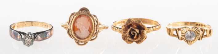A group of four 9ct gold rings, including a 9ct gold single stone diamond ring, UK hallmark,