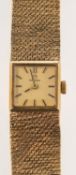 Omega a bark-finish gold lady's wristwatch the square dial with raised baton numerals,
