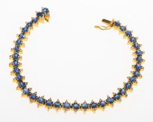 A sapphire and diamond line bracelet, of articulated links,