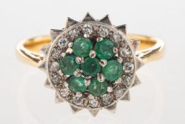 An emerald and diamond cluster ring, of flowerhead form,