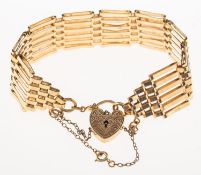 A gate bracelet with heart padlock, the heart padlock with foliate engraving to front, safety chain,