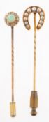 Two antique stick pins, one set with an opal cabochon with a surround of old mine-cut diamonds,