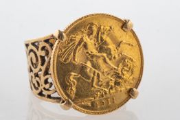 A George V 1911 half sovereign ring, in an ornate openwork ring mount (broken), unmarked, approx.