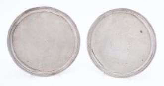 A pair of 18th century silver patens marks almost rubbed out, probably London 1718?,
