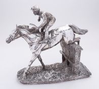 An Elizabeth II silver covered resin horse racing sculpture 'Over the Sticks' by Camelot Silverware