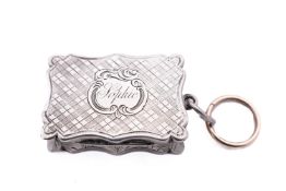 A Victorian silver vinaigrette by Edward Smith, Birmingham 1855, scrolled rectangular form,