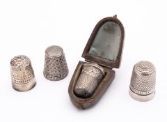 A group of antique sewing accessories including; a Chester silver thimble by James Walker Ltd,