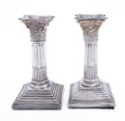A pair of silver plated Corinthian candlesticks, not marked, with detachable scones, 16cm. (6.