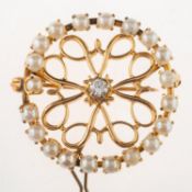 A pearl and diamond brooch, of circular openwork form,