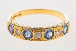 An 18ct gold sapphire and diamond eternity ring, set with four circular-cut sapphires,
