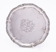 A George III silver waiter by Ebenezer Coker, London 1764, of circular form, with gadrooned rim,