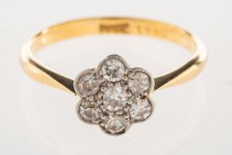 A diamond daisy ring, of flowerhead design set with old eight-cut diamonds, marked 18ct, size O, 2.