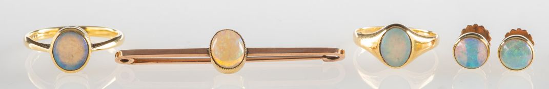 A group of opal set jewellery, including a signet style ring set with an oval opal cabochon,