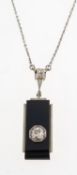 An Art Deco onyx and diamond necklace, the attached pendant of bi-metal and geometric design,