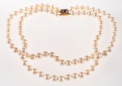 A cultured pearl necklace with an amethyst set clasp,