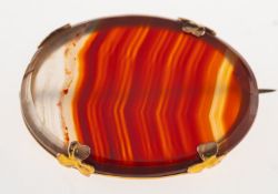 An agate brooch, claw set with an oval slice of agate, marked 9ct to verso, metal pin,