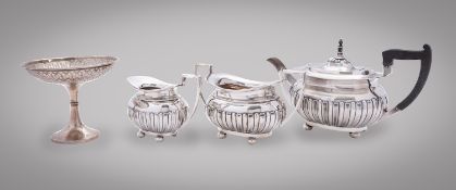 An Edward VII silver three piece tea service by Walker and Hall, Sheffield 1903,