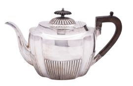 A Victorian silver tea pot by Harrison Brothers & Howson, Sheffield 1894, of serpentine form,