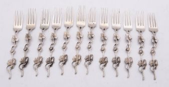 A set of twelve early 20th century French silver cast pastry forks, 12cms. long, 147.7gms. (4.75ozs.