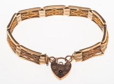 A gate bracelet with heart padlock, safety chain, heart with faint UK hallmark to verso,