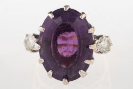 An 18ct gold amethyst and diamond ring, claw set with an oval-cut amethyst, amethyst approx. 14.
