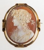 A large cameo brooch, depicting a maiden, openwork mount with some foliate engraving, unmarked,