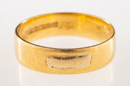 An 18ct gold wedding band, with two raised panels, UK hallmark, size R1/2, 3.6grams.
