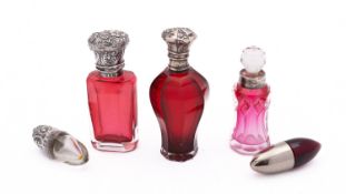 A mixed group of scent bottles including; a cranberry glass and silver bottle, Birmingham 1898,