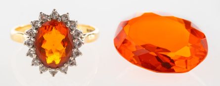 A fire opal and diamond cluster ring and an orange paste stone,