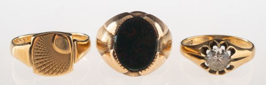 A group of three rings, including a 9ct gold signet ring set with bloodstone, UK hallmark, size R,
