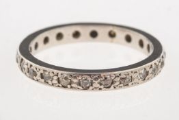 A full diamond eternity ring, a white metal ring set all the way around with brilliant-cut diamonds,
