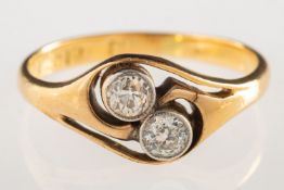 A two stone diamond ring, an open twist design ring, bezel set with two old-cut diamonds,