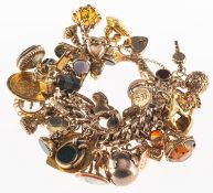 A charm bracelet with charms, the charm bracelet of fancy engraved links,