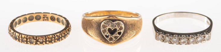 A group of three rings, including an 18ct white gold seven stone ring,