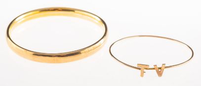 Two antique bangles, including a 9ct gold plain hollow bangle/arm cuff, UK hallmark,