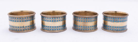 A set of four Victorian silver gilt and enamel napkin rings by Elkington & Co (Frederick Elkington),
