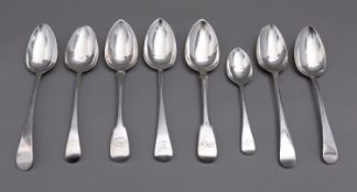 A mixed group of silver spoons including; five George III Old English pattern table spoons,