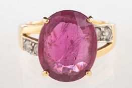 An 18ct gold ruby and diamond ring, claw set with an oval-cut ruby, ruby approx. 5.