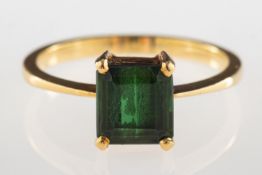 A green tourmaline ring, claw set with a rectangular table-cut green tourmaline, approx. 1.