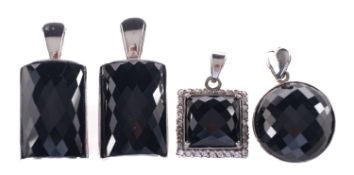 A group of four black faceted stone pend
