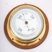 A brass bulkhead barometer, maker Kelvin