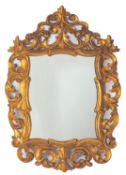 A carved and giltwood framed wall mirror
