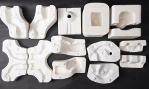 A collection of various plaster doll mou