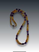An Unusual Polished Opal Bead and Faceted Amethyst Bead Necklaceslightly graduated, the largest bead