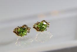 A Pair of Heart Shaped Peridot and Aquamarine Earrings mounted in yellow metal, set in 9 c gold,