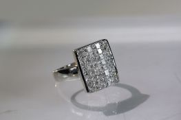 An Unusual Invisibly Set style Princess Cut Diamond Dress Ringmounted in 18 carat white gold,