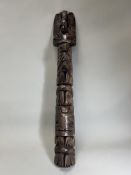 A model totem pole. Northwest Coast Canada.Carved in wood with a stacked arrangement of totemic