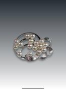 A Cultured Pearl and Silver Cluster Brooch set with sixteen 5.4mm.cultured pearls of good