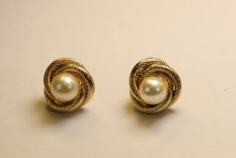 A Pair of Cultured Pearl and 9 ct Yellow Gold Knot Cluster Earstuds Each set to the centre with a