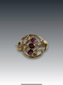An Antique Almandine Garnet and 15 ct Yellow Gold Brooch, circa 1860 the scrolled oval design brooch